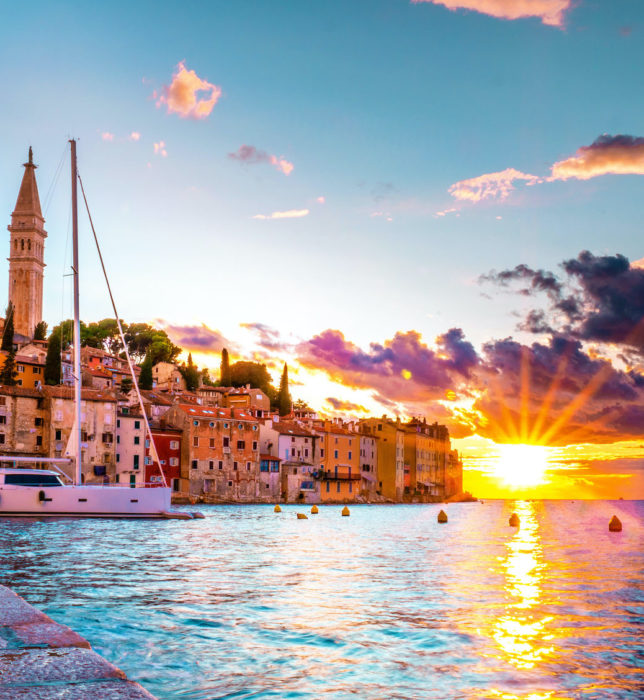 Rovinj colorful town Croatia, sunset Rovinj historical town with church and ocean