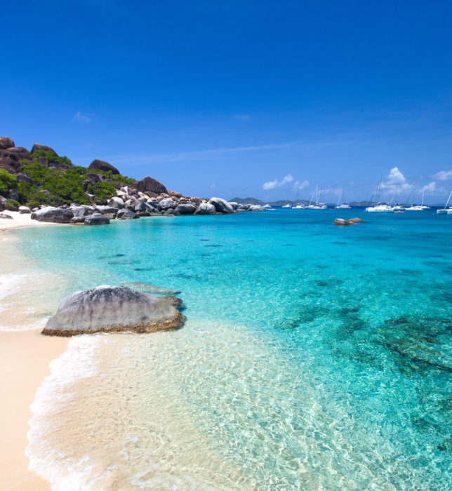 Stunning beach with white sand, unique huge granite boulders, turquoise ocean water and blue sky at Virgin Gorda, British Virgin Islands in Caribbean